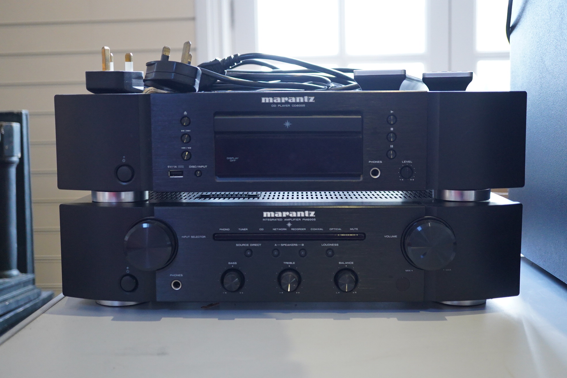 A Marantz HiFi integrated amplifier PM6005, together with a CD player CD6005, plus two remote controls and power leads